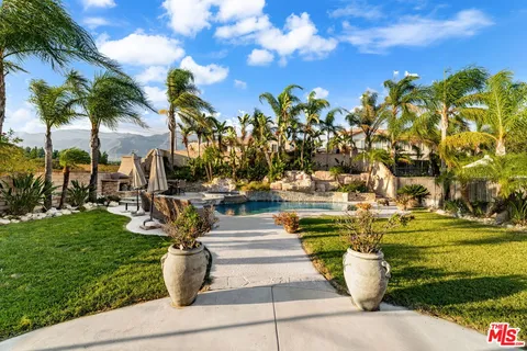 a view of swimming pool with outdoor seating and plants