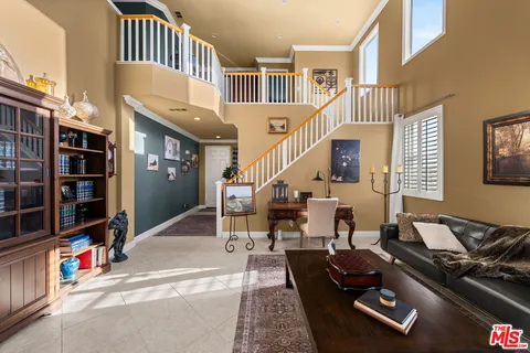 a view of a livingroom with furniture and staircase