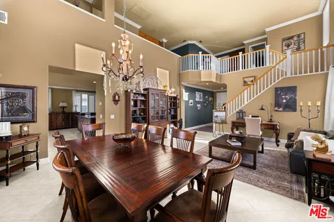a view of a dining room with furniture and a chandelier