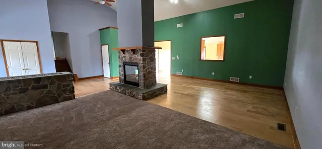 a room with fireplace and wooden floor