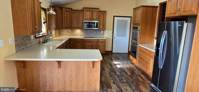 a view of hallway with a large window and wooden floor