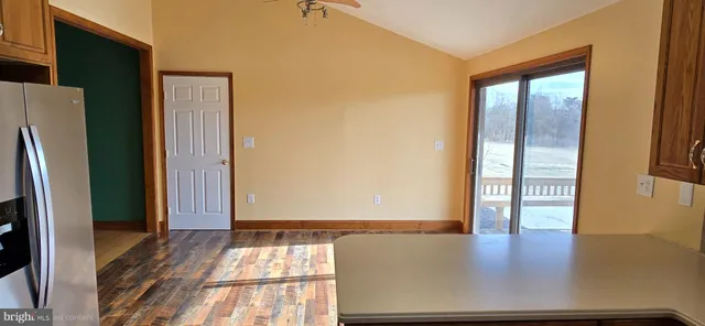 a view of a room with wooden floor and window