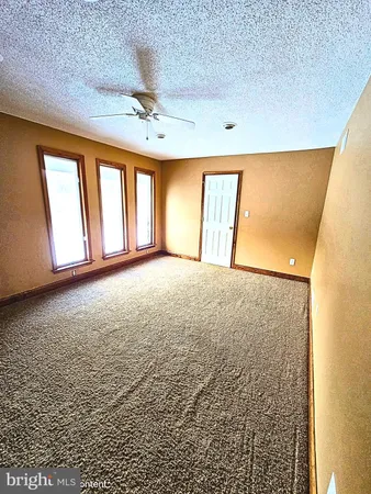 a view of an empty room with a fireplace