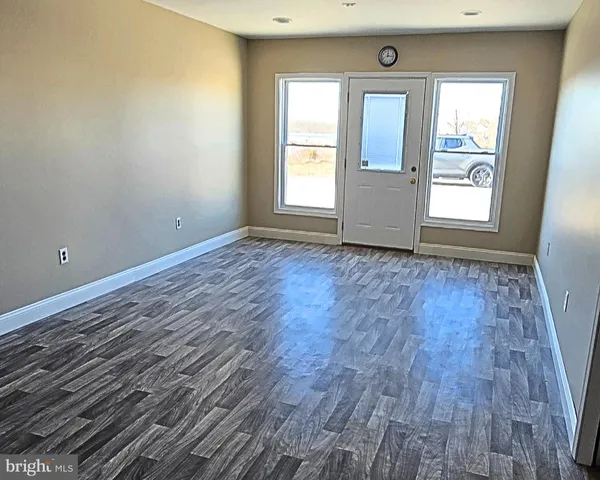 a picture of a room with a white wall and white cabinet