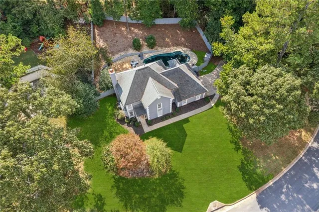 an aerial view of a house with a yard