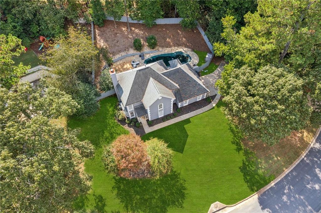 an aerial view of a house with a yard