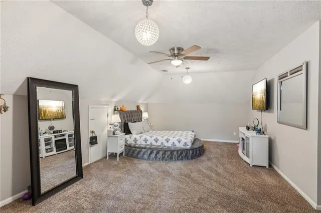 a spacious bedroom with a bed and dresser