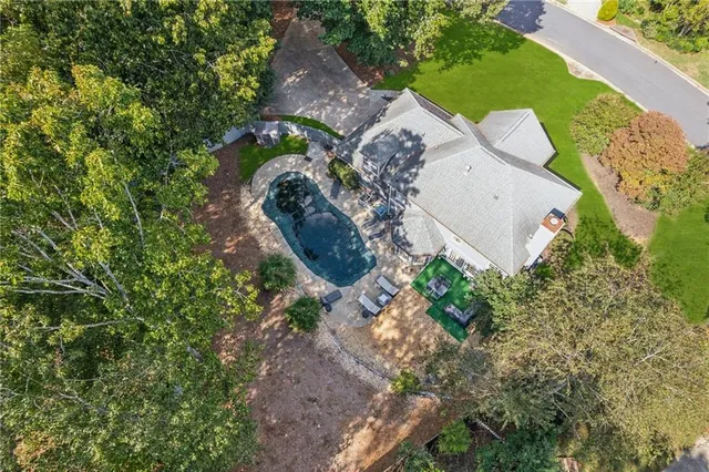 an aerial view of a house with a yard swimming pool and outdoor seating
