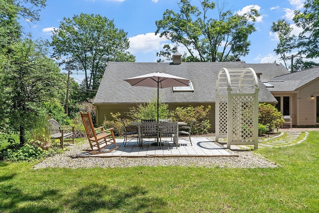 8 Piper Road Acton, MA 01720 - Photo 7 of 42 a view of a patio with table and chairs under an umbrella