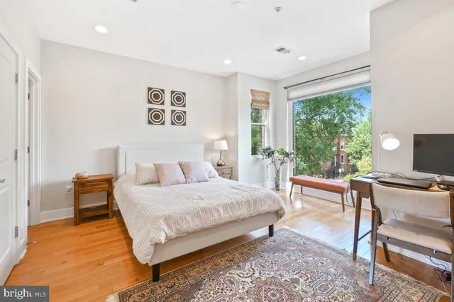 a bedroom with a bed and a desk