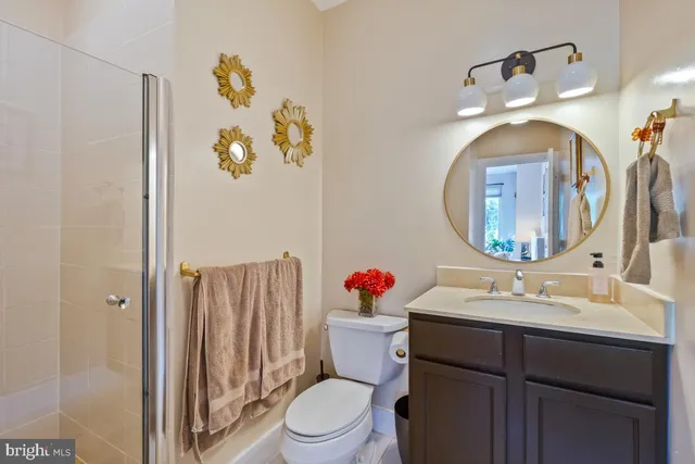 a bathroom with a sink mirror vanity and toilet