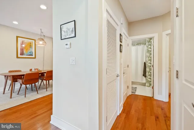 a view of a hallway with dining area and glass door