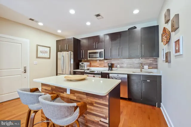 a kitchen with a sink refrigerator and cabinets