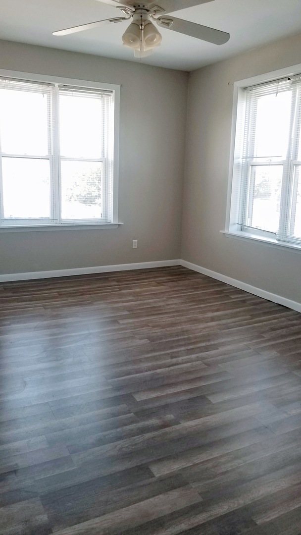 4764 North Virginia Avenue, Unit 306 Chicago, IL 60625 - Photo 9 of 16 wooden floor in an empty room with a window