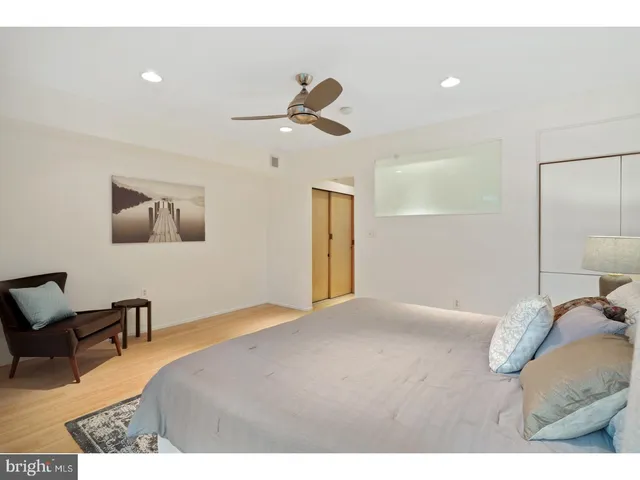 a bedroom with a bed and cabinets