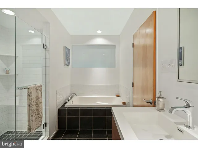 a bathroom with a bathtub and a sink