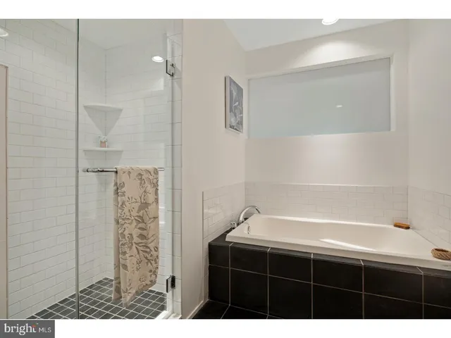 a bathroom with a bathtub and shower