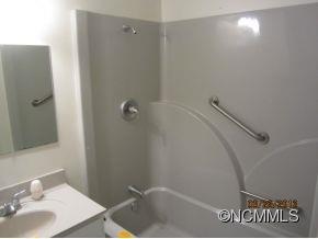 85 Riversedge Way Canton, NC 28716 - Photo 8 of 12 a bathroom with a sink and shower