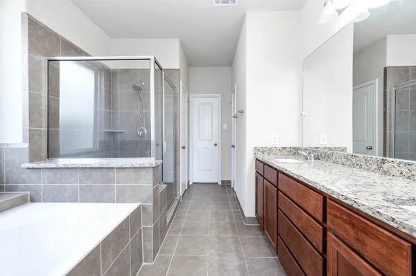 a bathroom with a tub sink and shower
