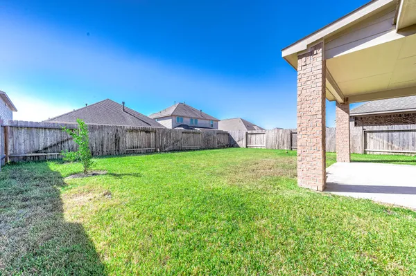 a view of a house with a yard and a fountain