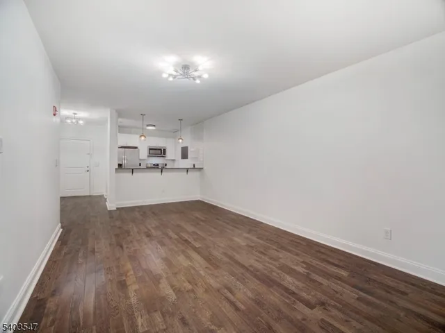 a view of a kitchen with a sink and wooden floor