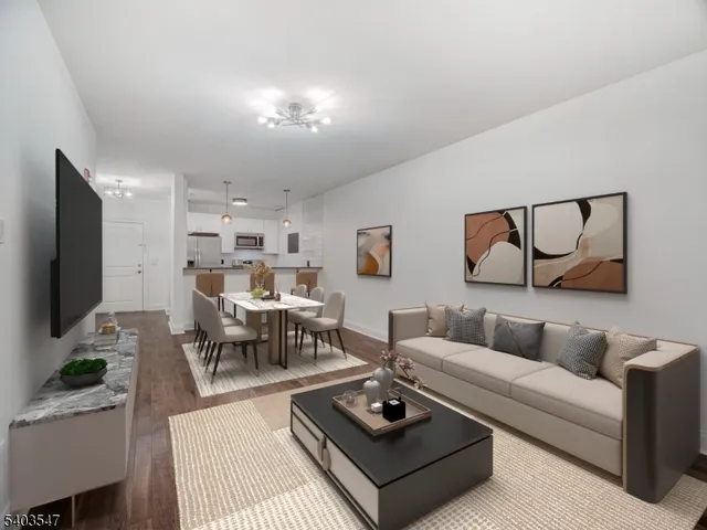 a living room with furniture a rug and a flat screen tv