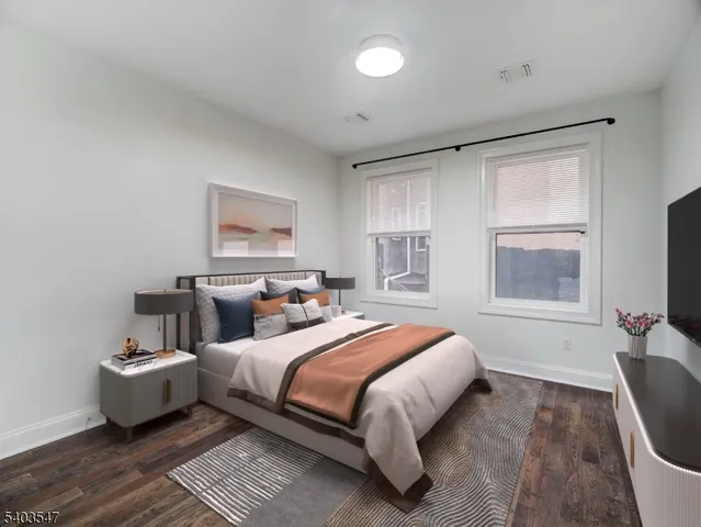 a bedroom with bed couch and window