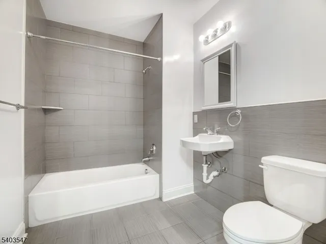 a bathroom with a sink a toilet and bathtub