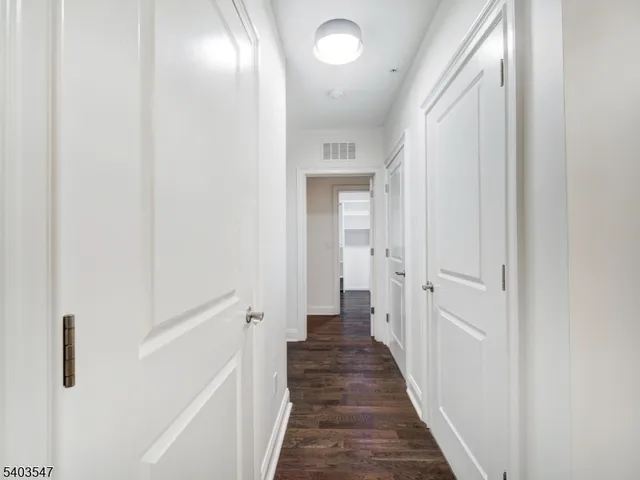 a view of a hallway with a wooden floor