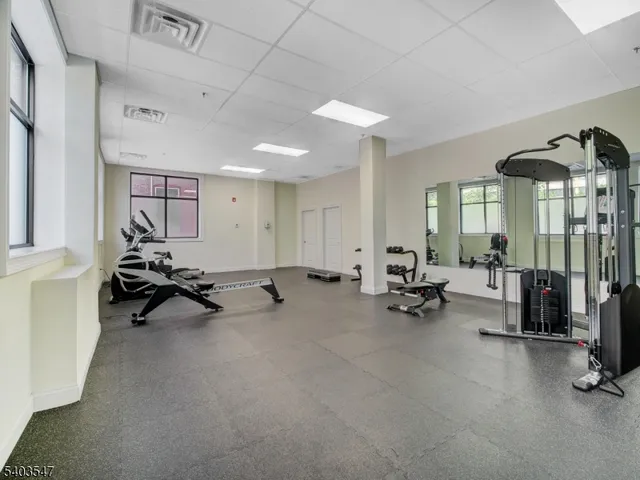 a view of a room with gym equipment and a large window