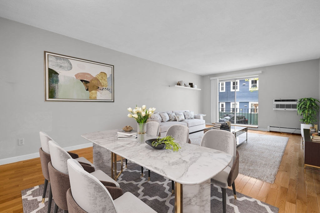 a view of a dining room with furniture window and wooden floor