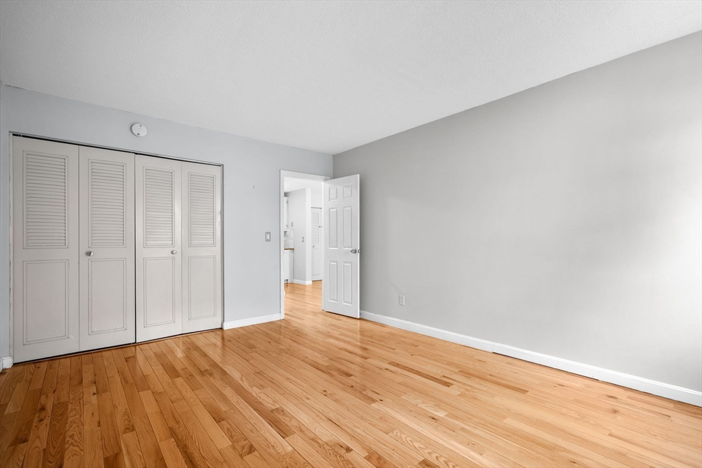804 Centre Street, Unit 104 Boston, MA 02130 - Photo 11 of 32 a view of an empty room with wooden floor