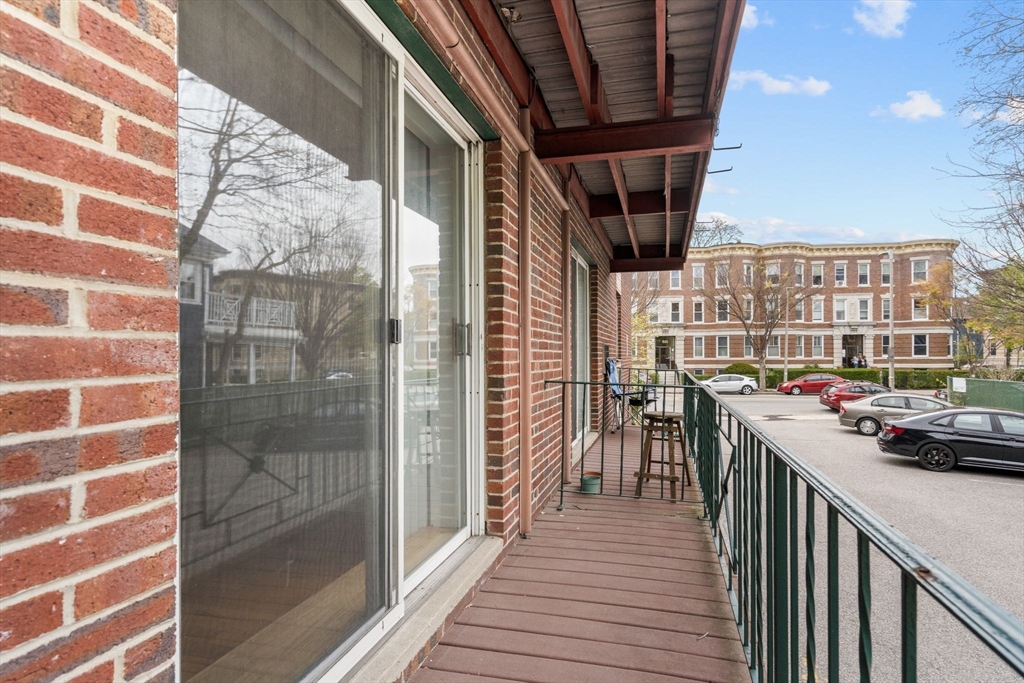 804 Centre Street, Unit 104 Boston, MA 02130 - Photo 16 of 32 a view of a balcony with wooden floor