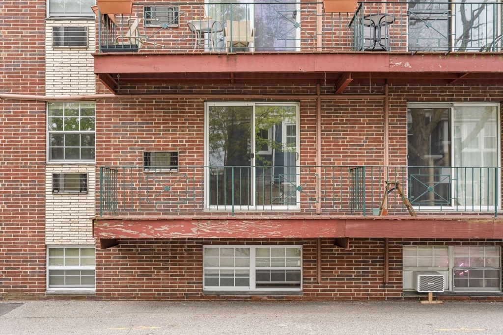 804 Centre Street, Unit 104 Boston, MA 02130 - Photo 18 of 32 a front view of a house with a parking space