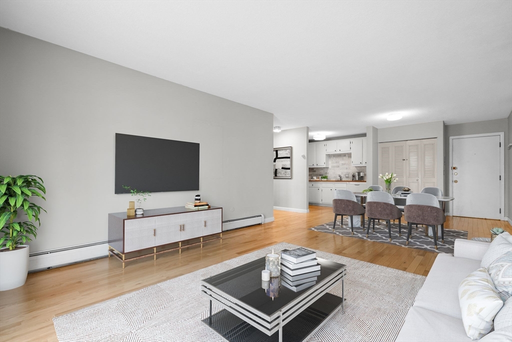 804 Centre Street, Unit 104 Boston, MA 02130 - Photo 2 of 32 a living room with furniture and a flat screen tv