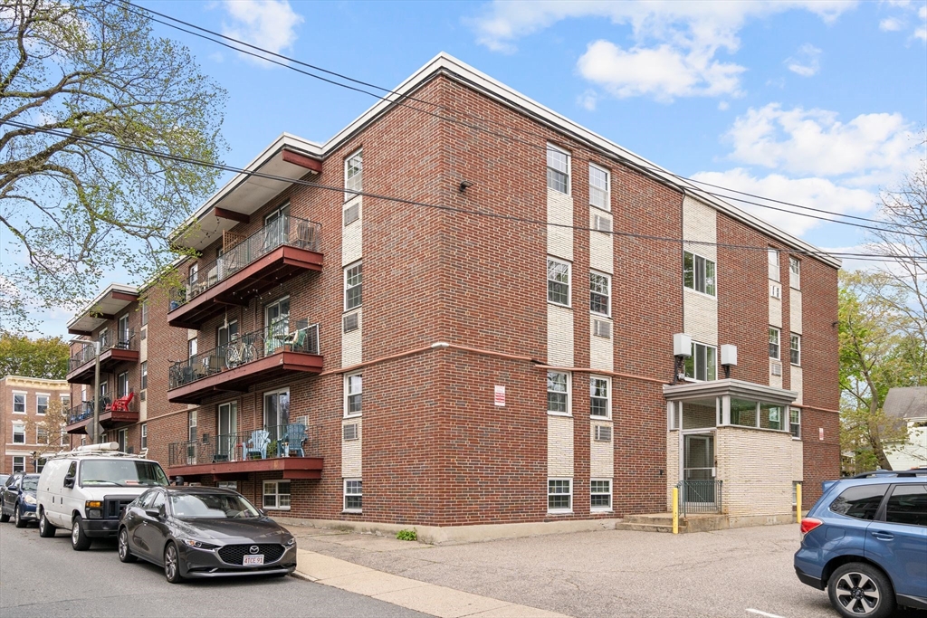 804 Centre Street, Unit 104 Boston, MA 02130 - Photo 32 of 32 a car parked in front of a house