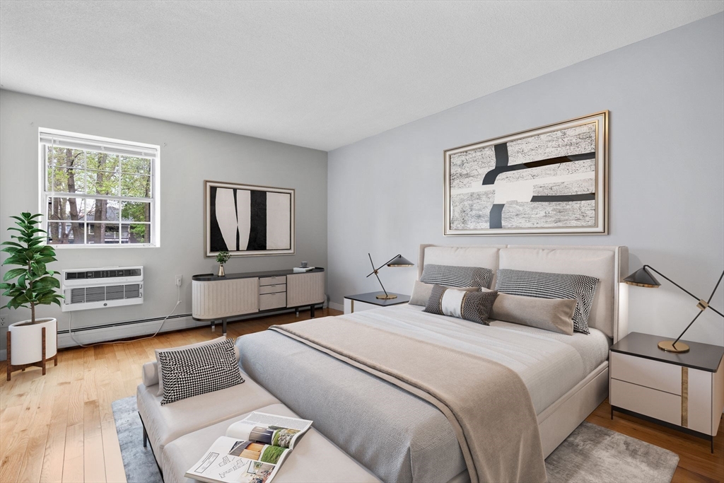 804 Centre Street, Unit 104 Boston, MA 02130 - Photo 8 of 32 a bedroom with a large bed and a couch