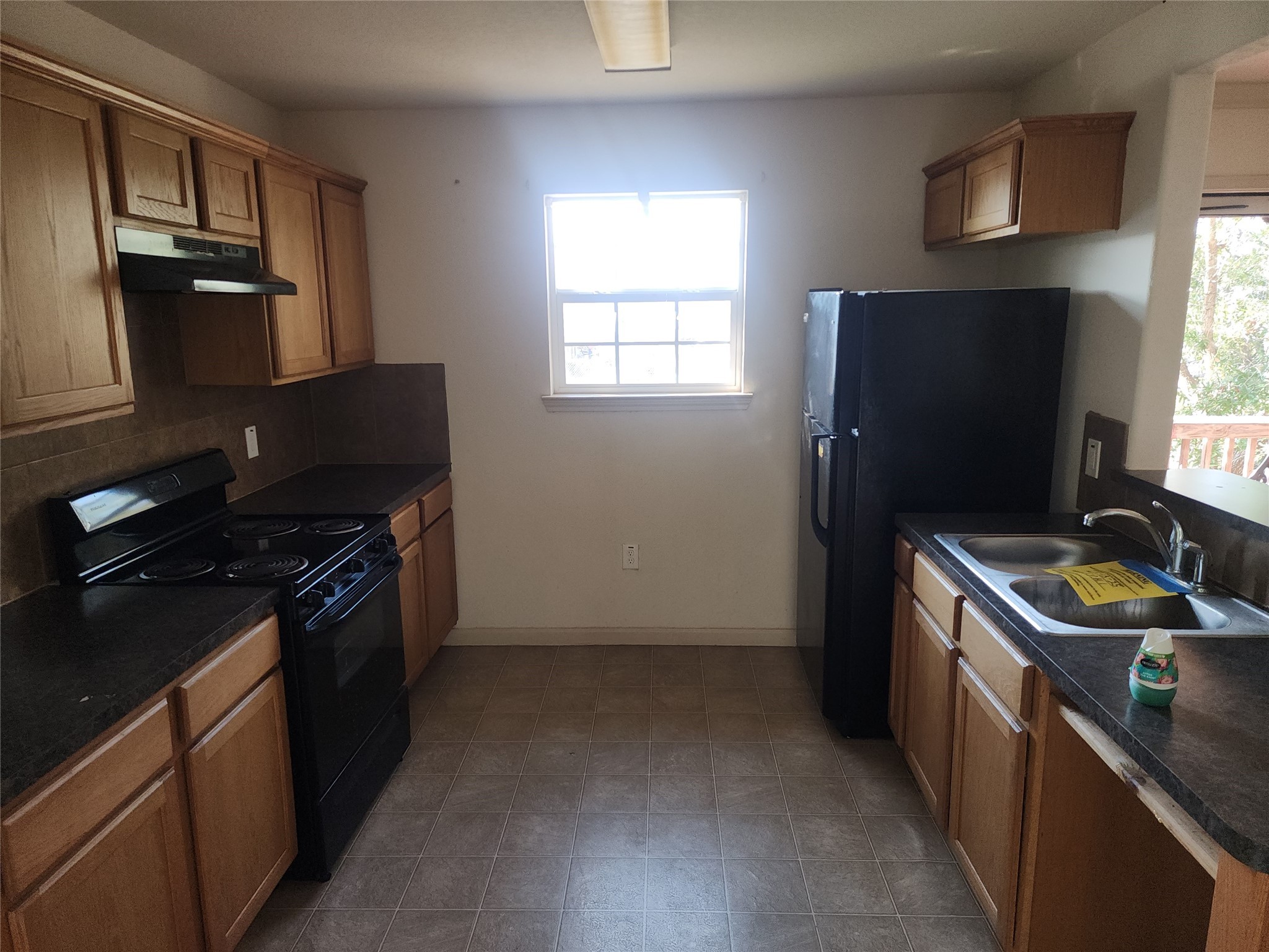 315 20th Street Dickinson, TX 77539 - Photo 11 of 19 a kitchen with granite countertop a stove and a refrigerator
