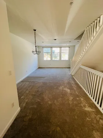 a view of empty room with stairs