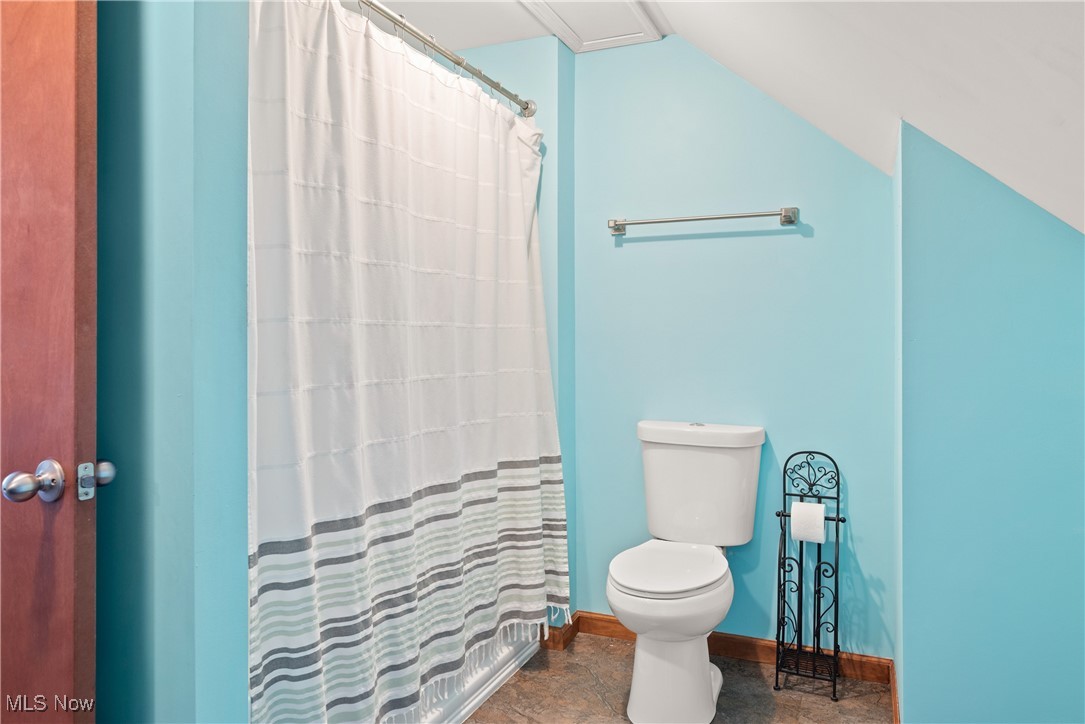 399 Wilder Road Vinton, OH 45686 - Photo 25 of 36 Bathroom with a shower with shower curtain, stone finish flooring, and lofted ceiling