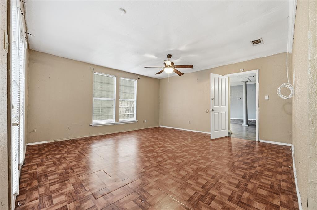 414 Thomas Street Terrell, TX 75160 - Photo 12 of 20 a view of an empty room with window and chandelier fan