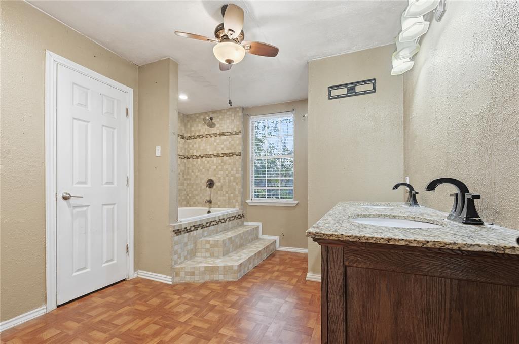 414 Thomas Street Terrell, TX 75160 - Photo 13 of 20 a spacious bathroom with a granite countertop sink a mirror and shower