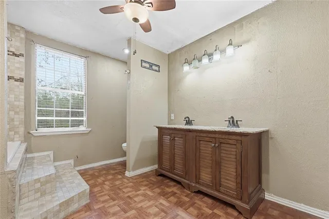 a view of a bathroom with sink and mirror