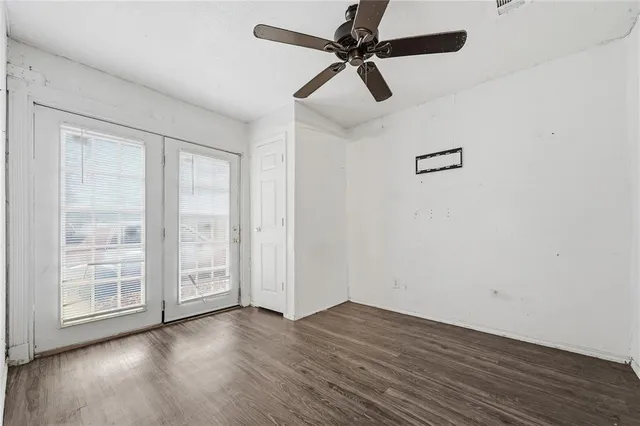 wooden floor in an empty room with a window