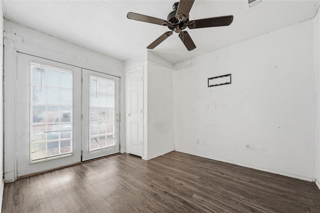 414 Thomas Street Terrell, TX 75160 - Photo 18 of 20 an empty room with wooden floor fan and windows