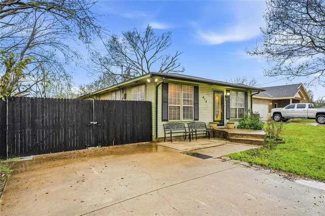 a backyard of a house with table and chairs