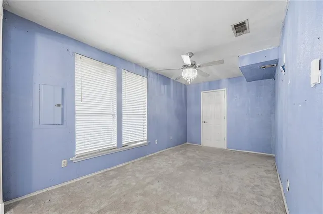 a view of a livingroom with a ceiling fan and window