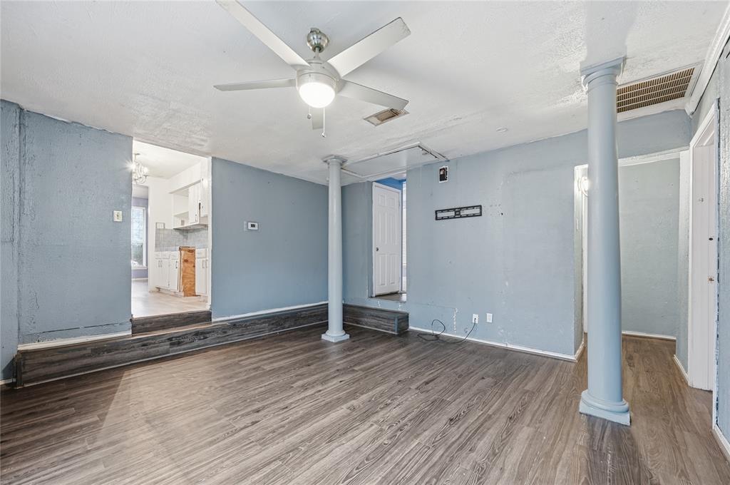 414 Thomas Street Terrell, TX 75160 - Photo 9 of 20 an empty room with wooden floor and window