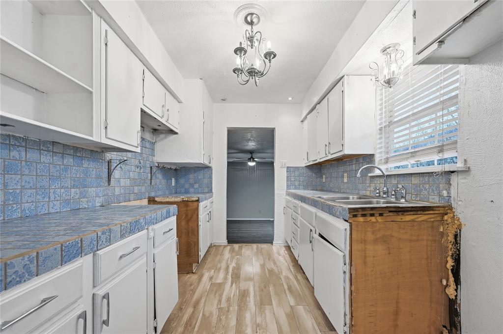 414 Thomas Street Terrell, TX 75160 - Photo 10 of 20 a kitchen with stainless steel appliances granite countertop a sink stove and refrigerator