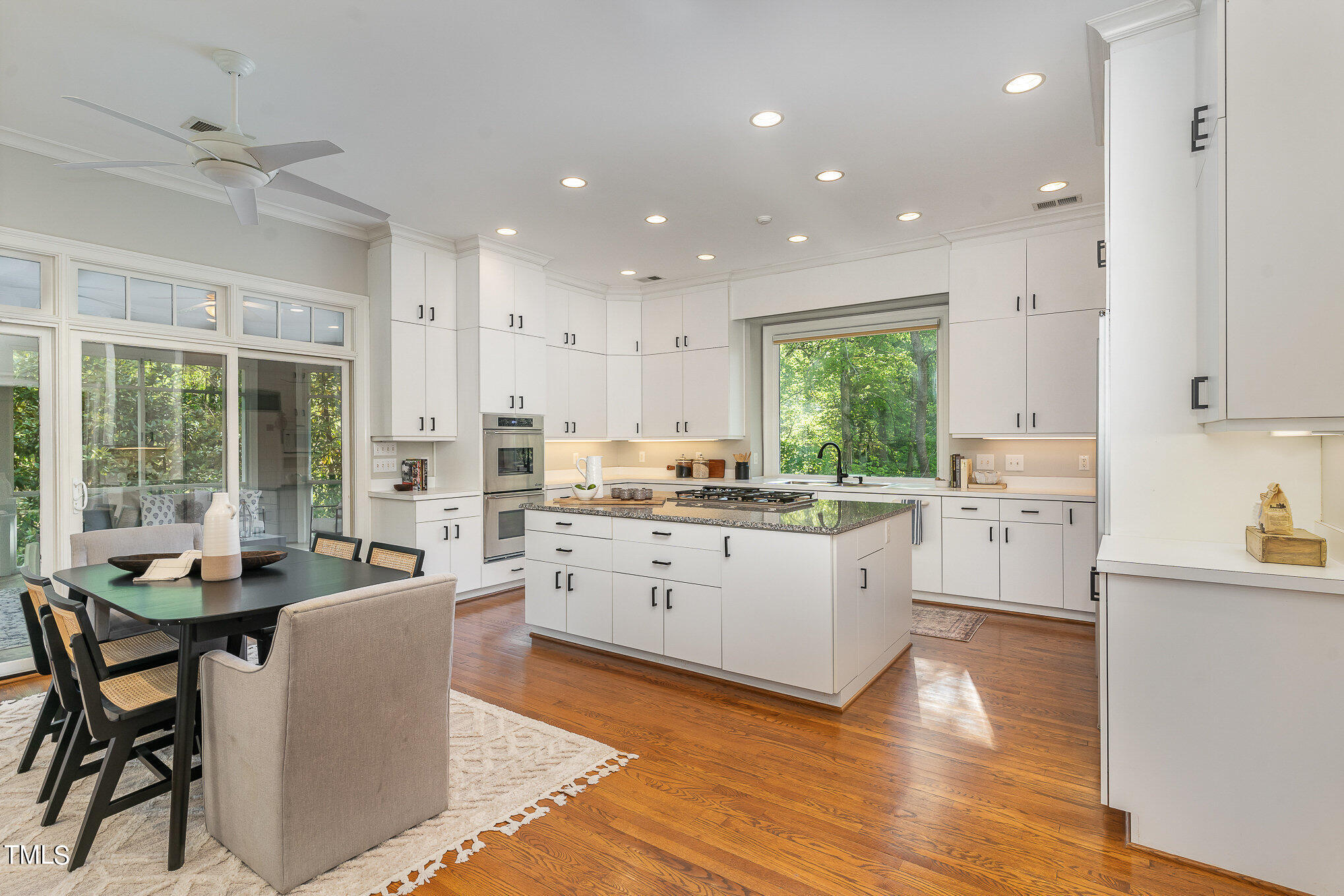 3737 Hope Valley Road Durham, NC 27707 - Photo 13 of 58 a large kitchen with white cabinets a counter space and stainless steel appliances